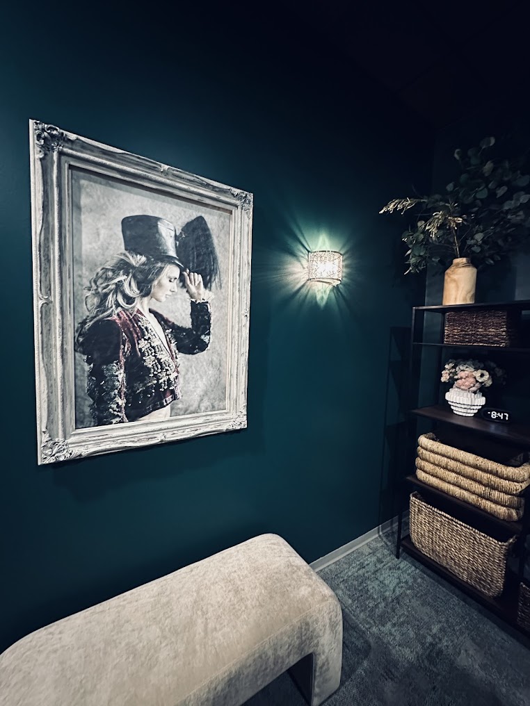 Editorial corner of the EvolvE sanctuary with warm wall sconce and curated decor
